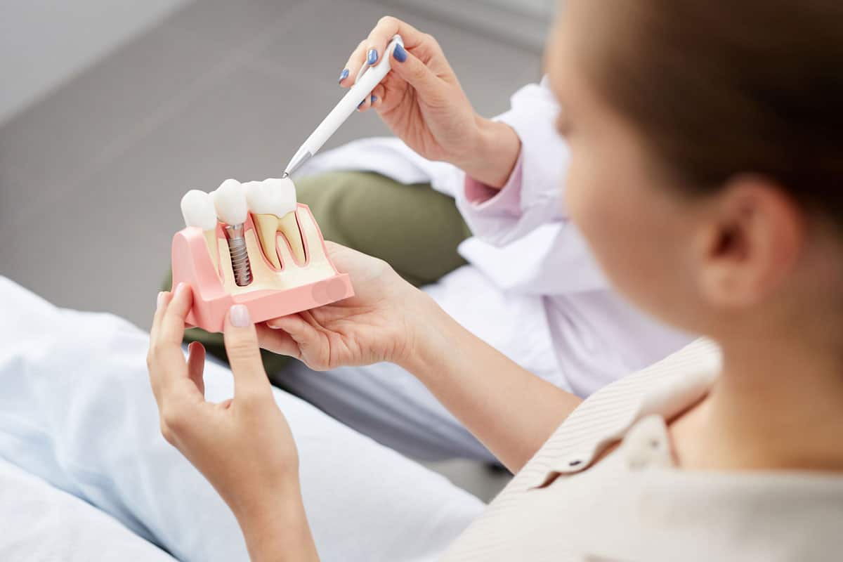 Person in dental chair holding dental model.jpg